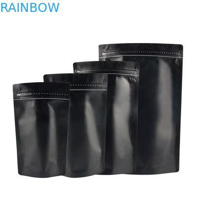 Ο Μαύρος μεταλλινών τελειώνει τη στάση φύλλων αλουμινίου επάνω στη συσκευάζοντας τσάντα καφέ τσαντών φερμουάρ με τις χρυσές λουρίδες